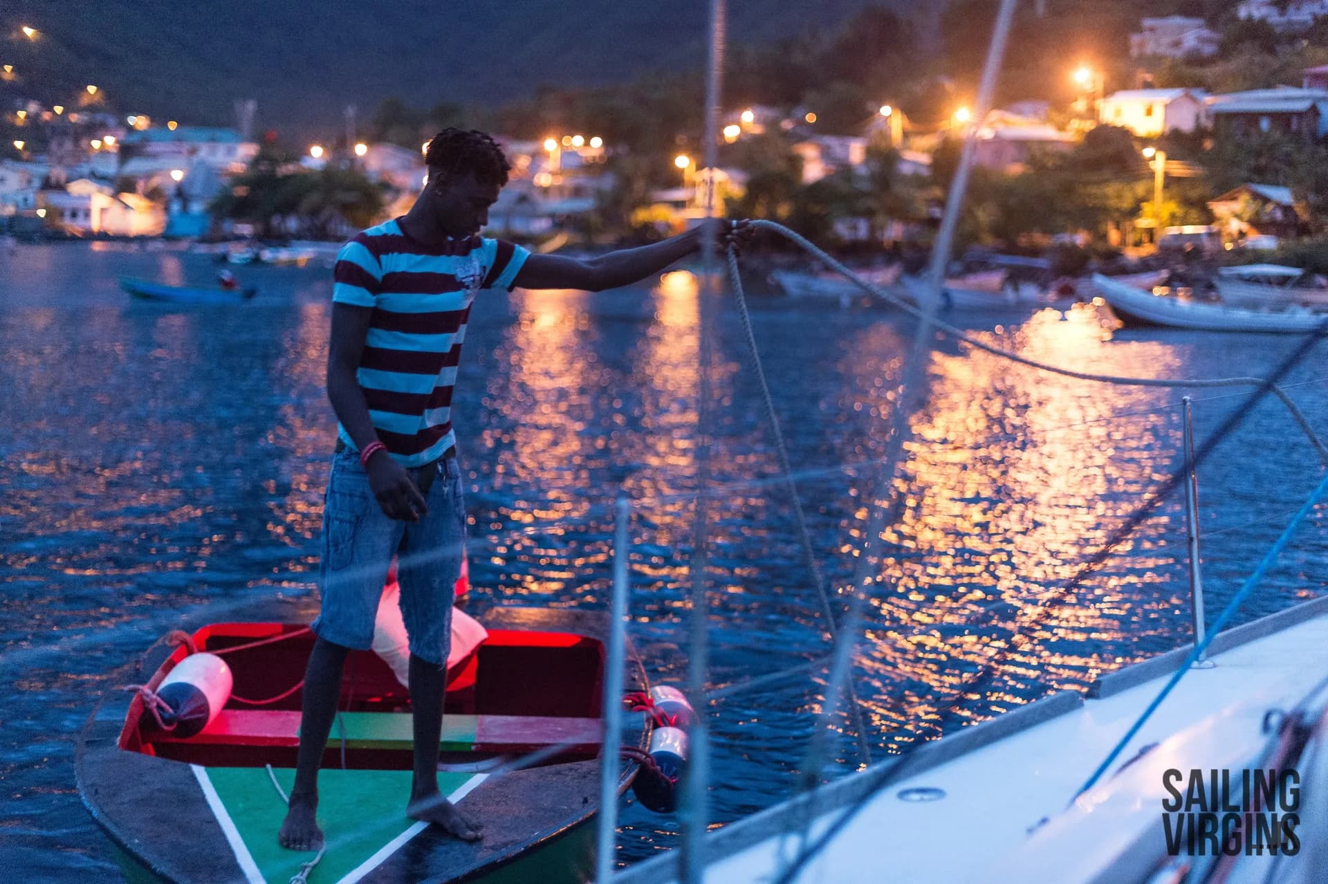 Night harbor scene with dinghy and yacht