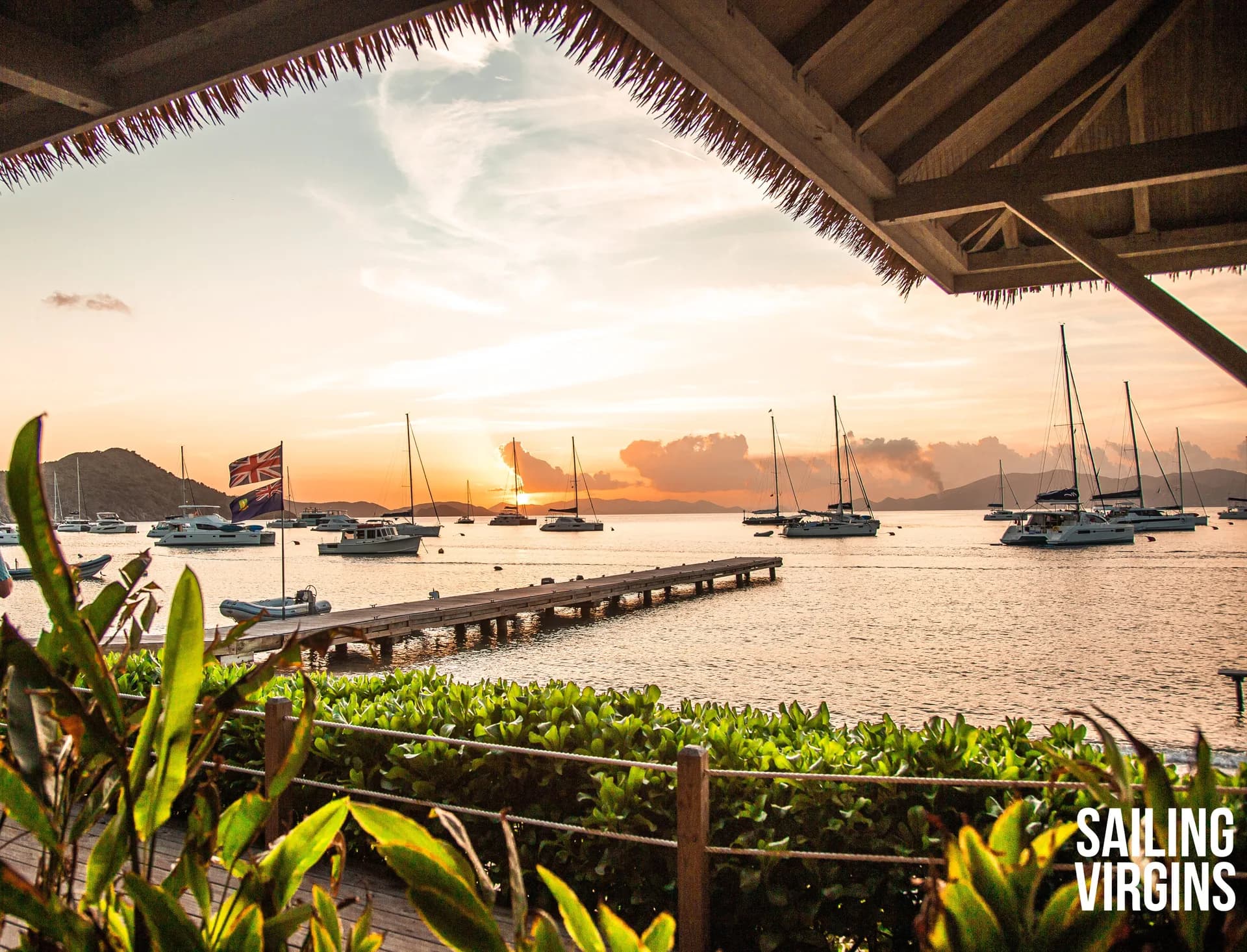Sunset over harbor with yachts at dock