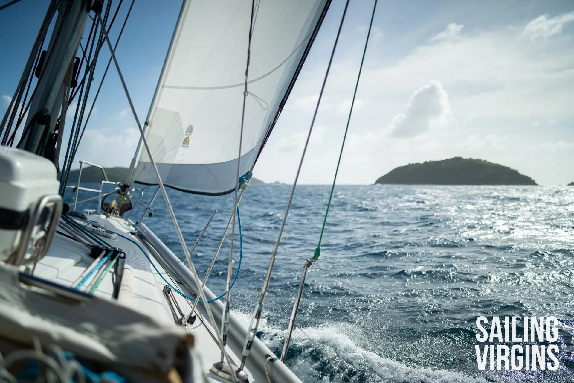 Monohull sailing in the Caribbean with island in background