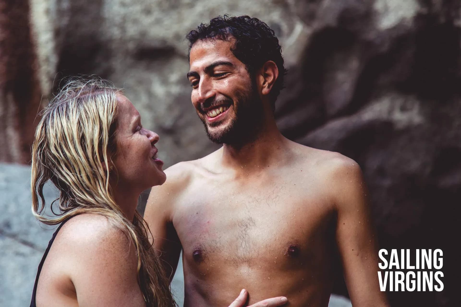 Couple laughing near a waterfall
