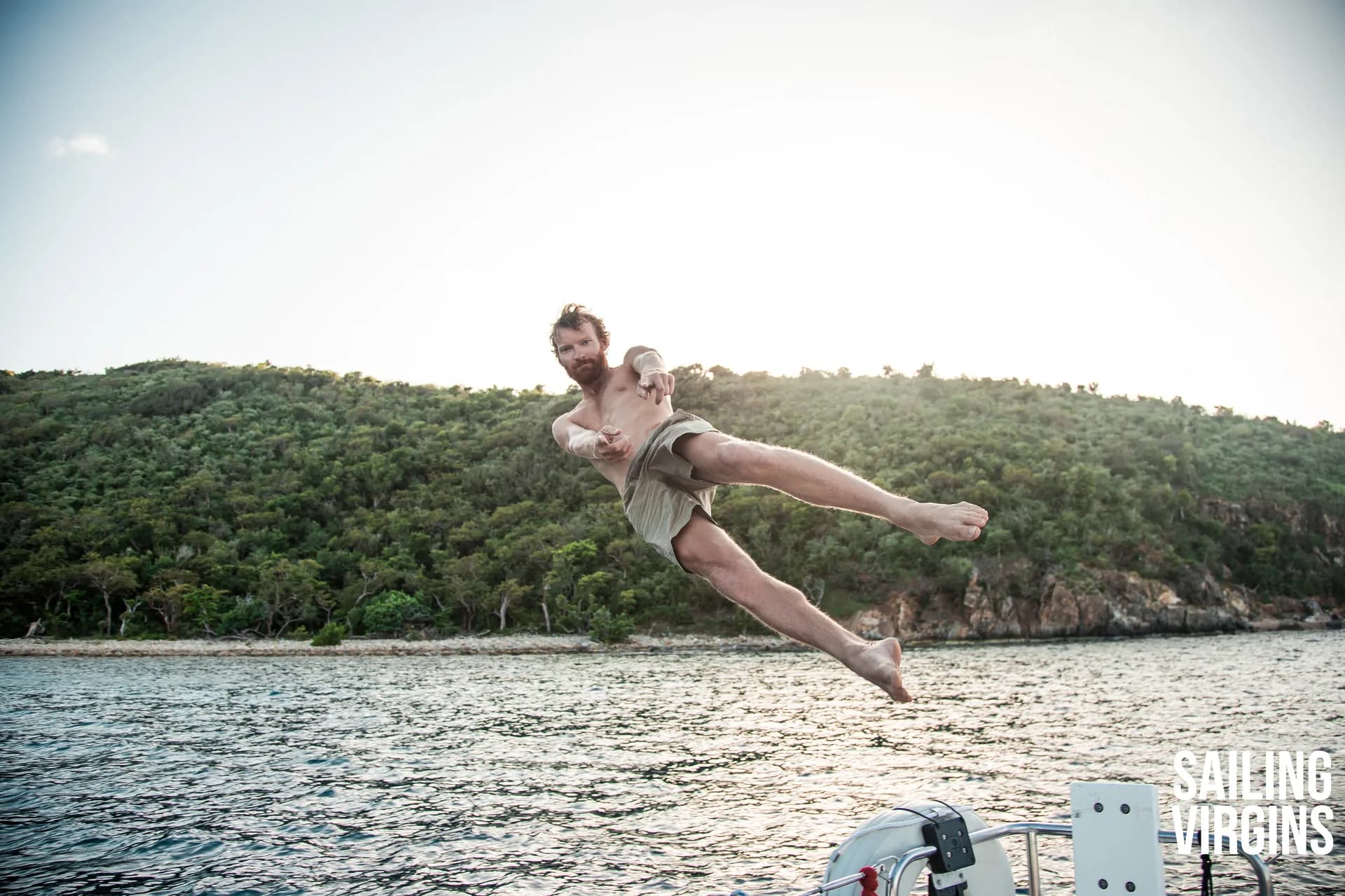 Student doing a flying jump off the boat