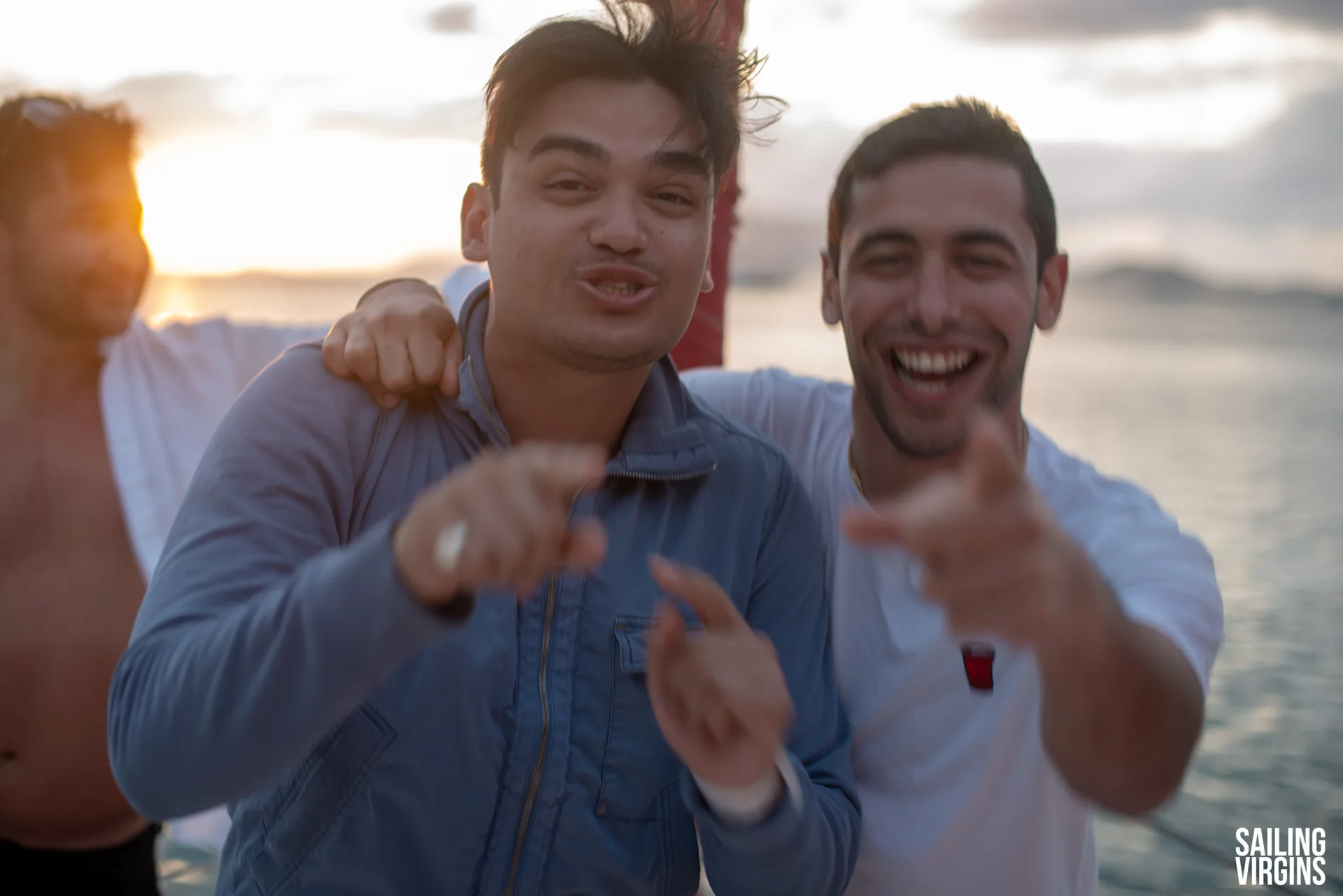Guys having fun on deck at sunset