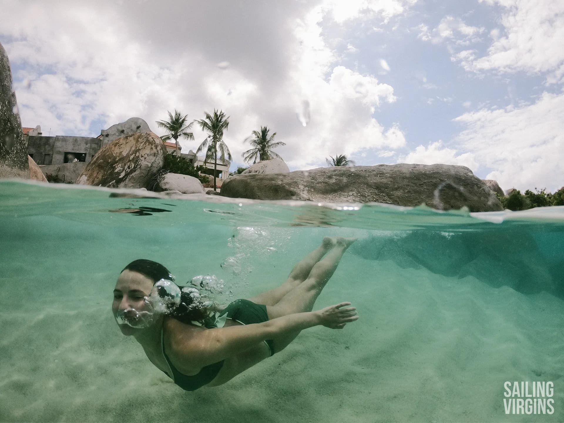 Split shot of swimming in the BVI with boulders