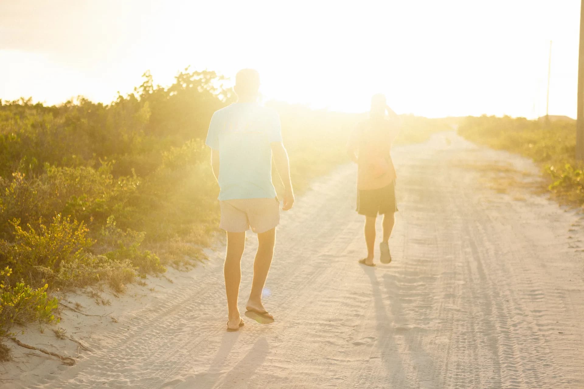 Walking a sandy path at sunset