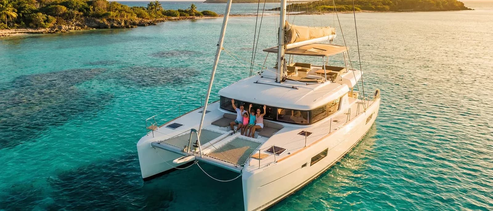 A catamaran at anchor in clear turquoise water
