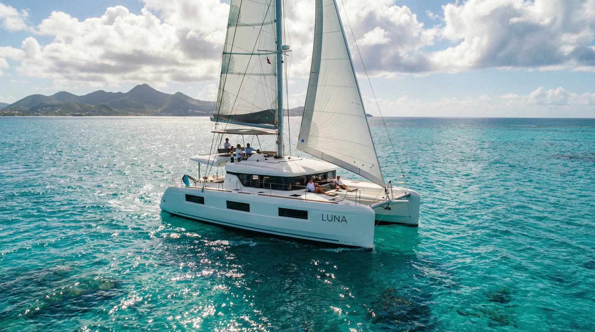 Sailing crew on yacht in St. Martin waters with turquoise Caribbean sea