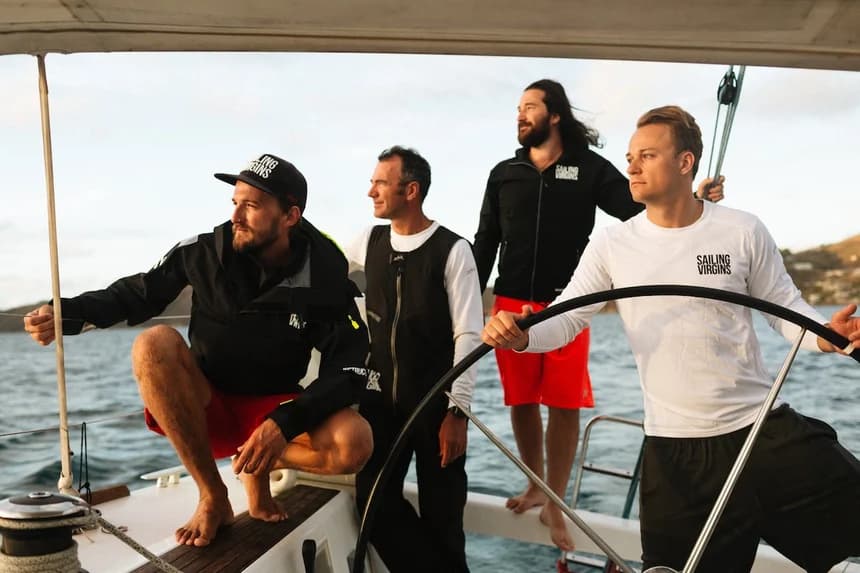 First-time sailor at the helm with instructor guidance, learning to steer in calm waters