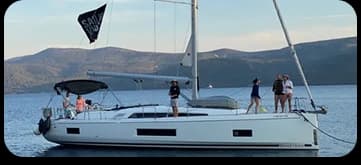 Intermediate sailors reviewing navigation charts together in the cockpit of a yacht in Croatia