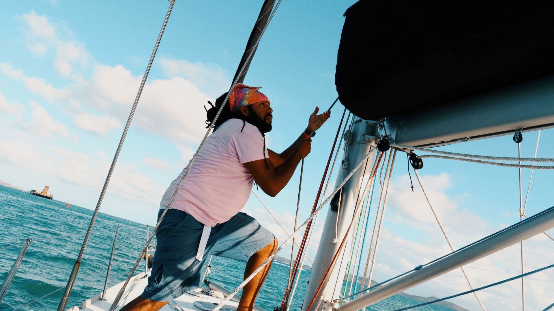 Crew working together to fly a spinnaker on a high-performance racing yacht
