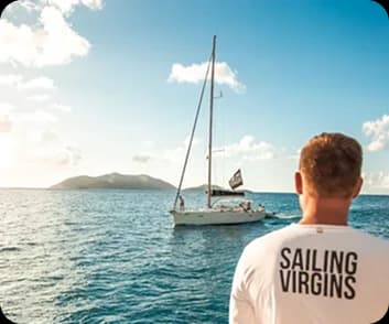 Yacht heeling dramatically in strong winds with confident crew